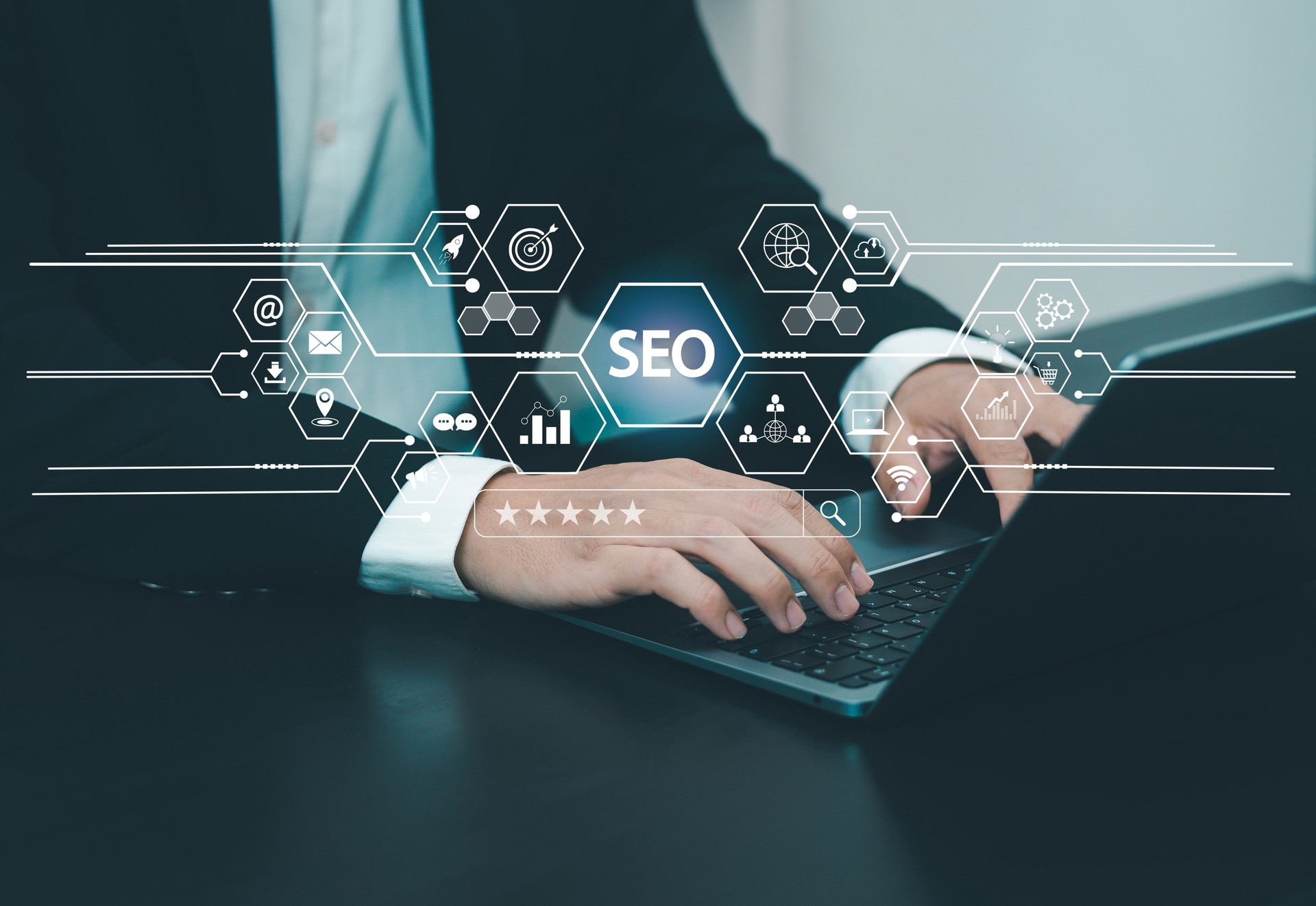 Businessman presses on laptop keyboard to use search engine (SEO) to find customers or promote and advertise online content for marketing technology and business solutions.
